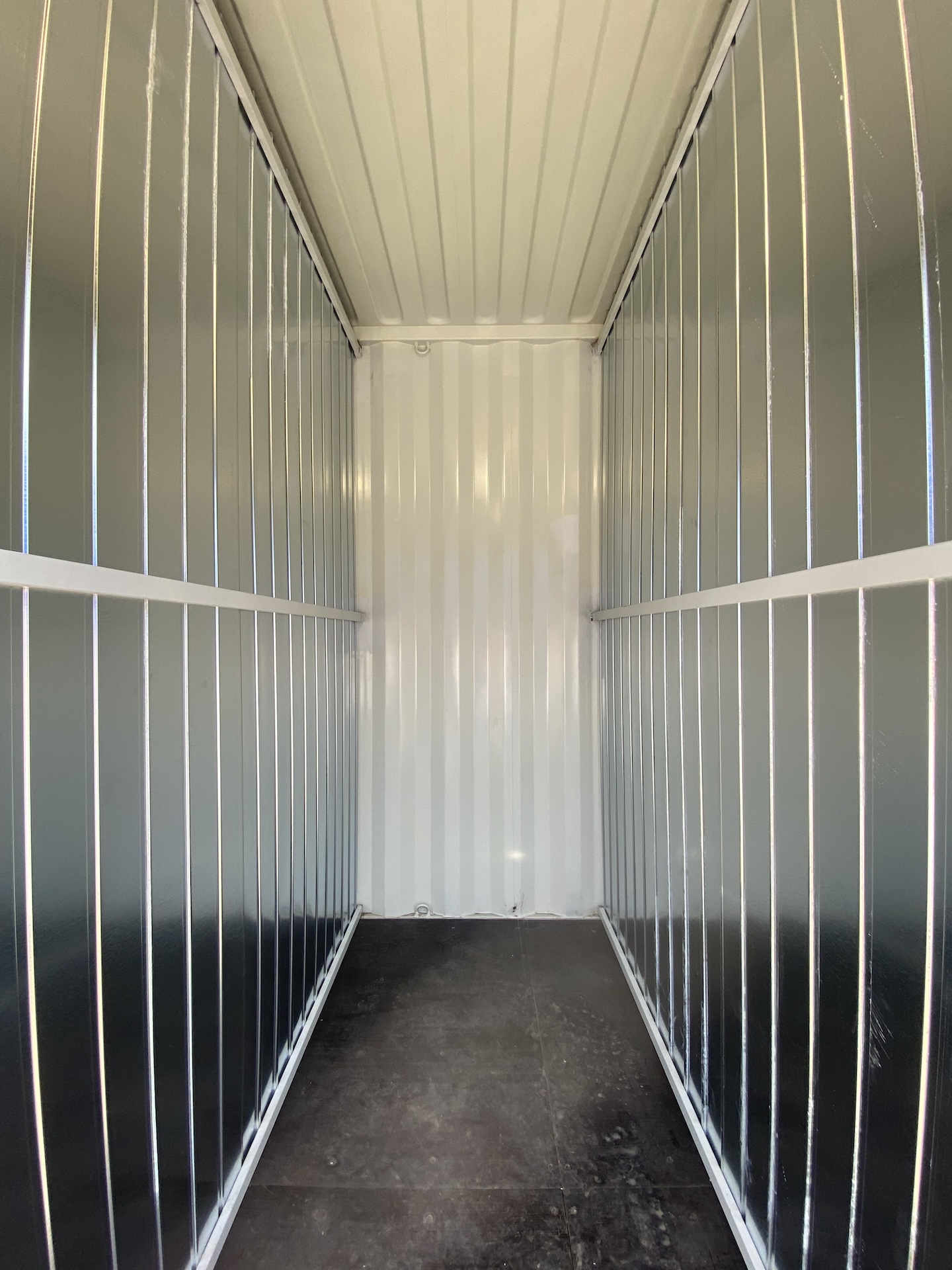 shelving with labeled archive boxes inside container